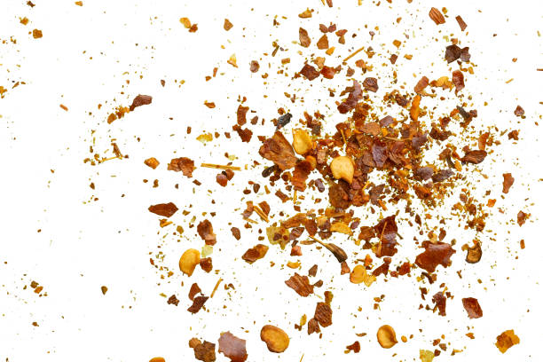 istock dried red chili pepper flakes and seeds isolated on white background 2156261816