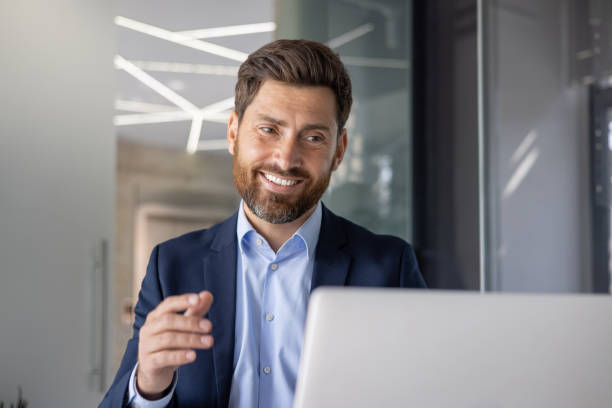 istock Confident businessman working on a laptop in modern office 2156261954