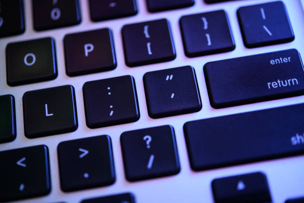 istock Close-up of Modern Black Keyboard with Glowing Blue Backlight, Focus on Enter Key 2156261984