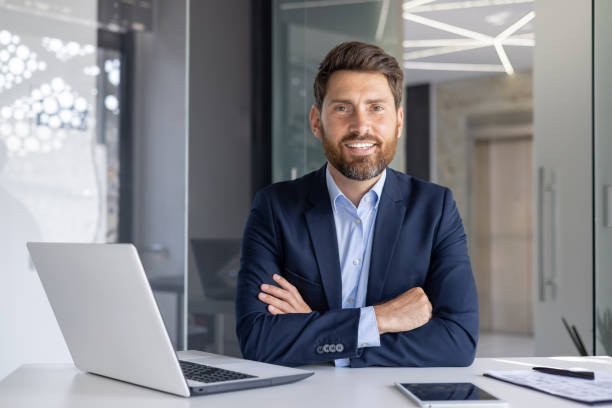 istock Confident businessman smiling at modern office desk 2156262174