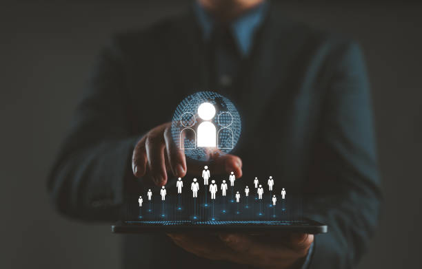 istock HRM human resource management concept, executive holding a magnifying glass to search for effective personnel, human resource management in the organization, human development and recruitment. 2156264802