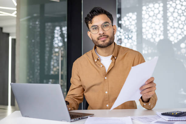 istock Young professional working with laptop and documents in modern office 2156265493
