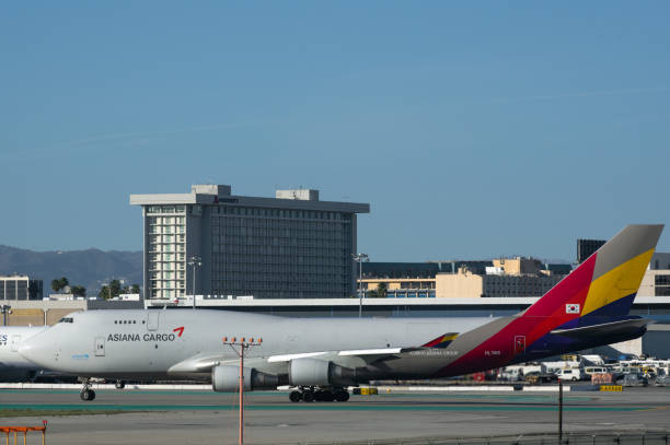 Asiana Airlines Boeing 747-400 quad-jet with registration number HL7415, cargo configuration, shown taxiing in preparation for take-off from LAX, Los Angeles International Airport.