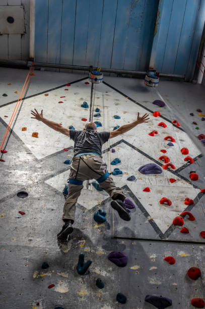 istock Mature man going down at indoor climbing 2156268464