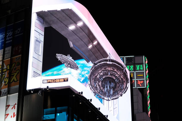 Realistic 3D spaceships floating by night at the Cross Shinjuku junction, a busy intersection in Tokyo, Japan.