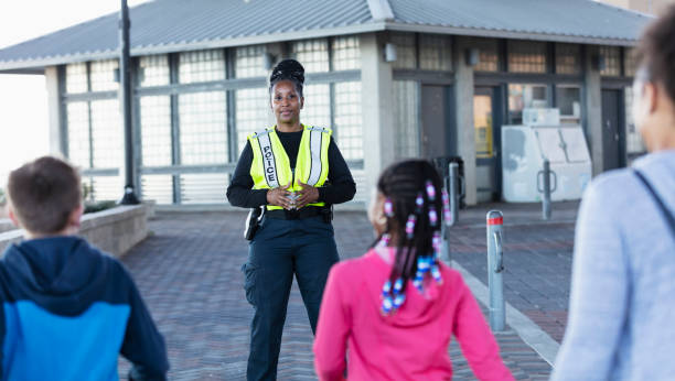 istock Policewoman on duty, standing outside a building 2156271808