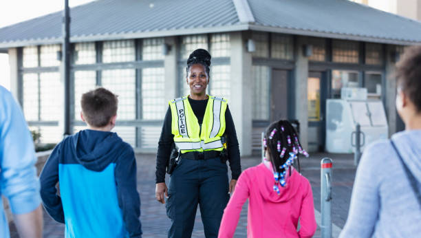 istock Policewoman on duty, standing outside a building 2156271837