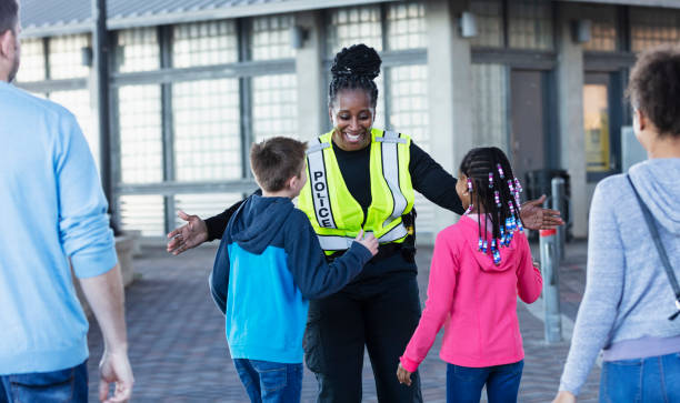 istock Policewoman greeting multiracial children with open arms 2156271842
