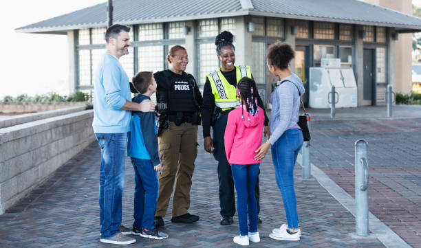 istock Policewomen talking with two families outdoors 2156271848