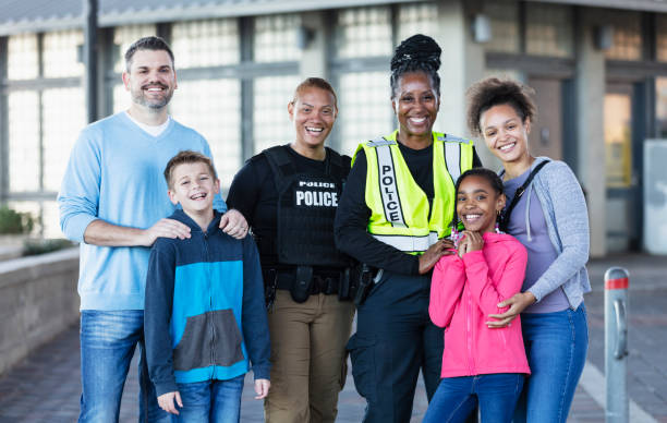 istock Two policewomen with members of community 2156271852