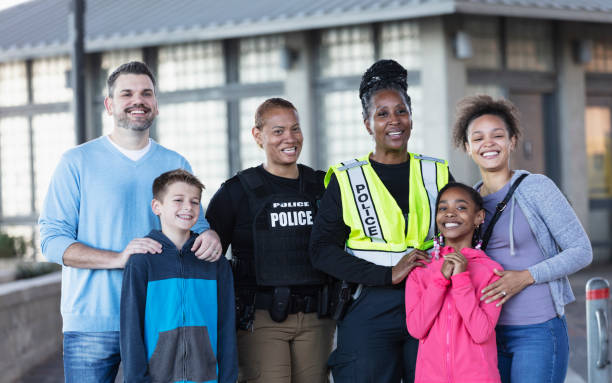 istock Two policewomen with members of community 2156271854