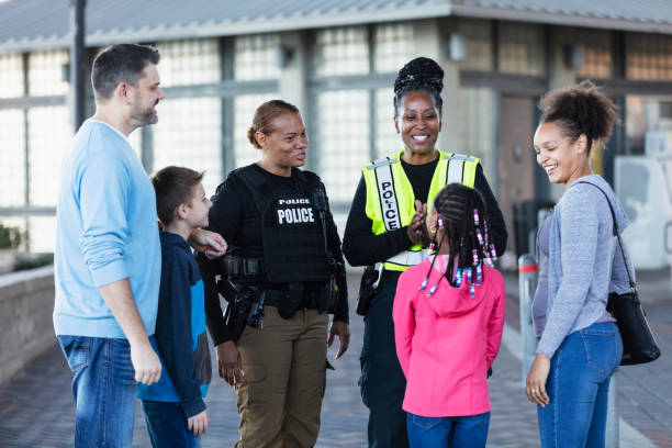 istock Policewomen talking with two families outdoors 2156271855
