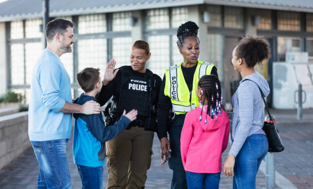 istock Policewomen talking with two families outdoors 2156271874