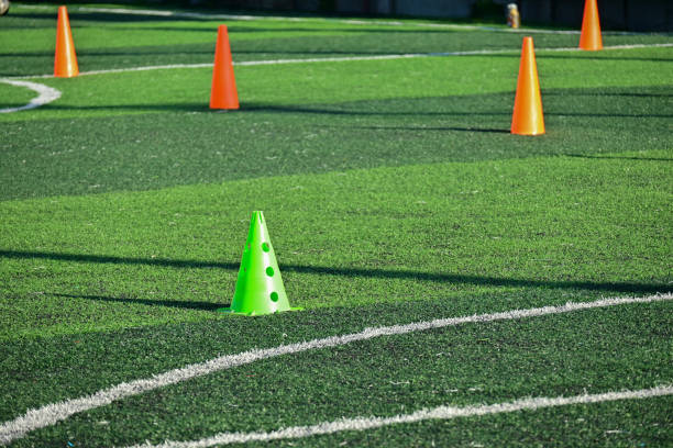 istock artificial green grass soccer field with orange training cones 2156277268