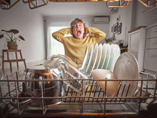 istock Boy screaming near dishwasher with kitchenware 2156278290