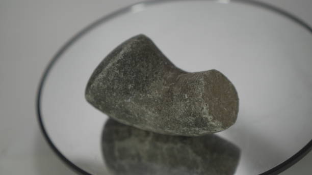 Stones for grinding spices usually have a special container made of stone so that if they rub against each other they can grind the spices until they are fine. The stone is called alu from Indonesia. This gray stone has been broken but can still be used as intended.