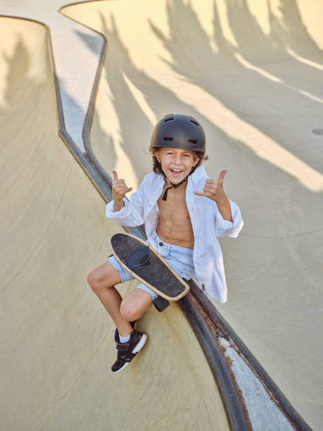 istock Cheerful boy in helmet with longboard 2156284151