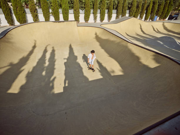 istock Boy riding longboard on sunny day 2156284208