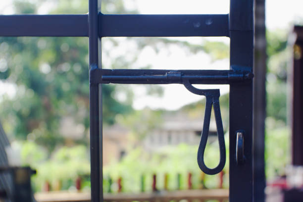The iron latch on the fence is black