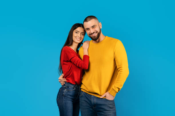 istock Man and woman are smiling and posing for photo in studio setting 2156285439