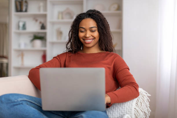 istock Relaxed black woman enjoying working from home, using her laptop computer 2156287638