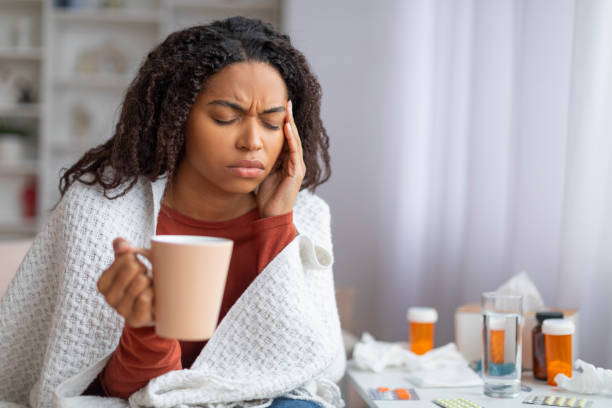 istock Sick young black woman suffering from headache or cold at home 2156287738