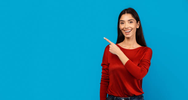 istock Woman Pointing at Something With Her Finger, Blank Space 2156287849