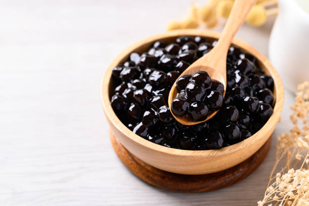 istock Black tapioca pearls or boba in wooden bowl with spoon, Ingredient in bubble tea 2156291055