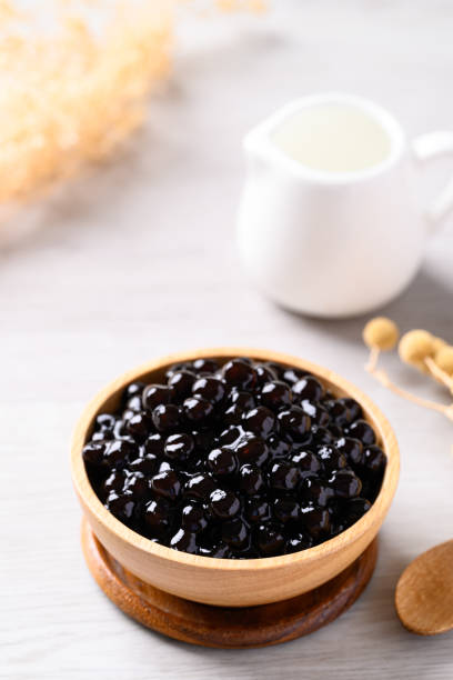 istock Black tapioca pearls or boba in wooden bowl, Ingredient in bubble tea 2156291122