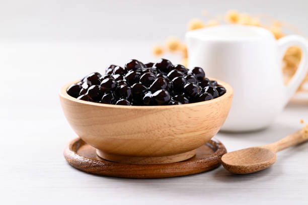 istock Black tapioca pearls or boba in wooden bowl, Ingredient in bubble tea 2156291128
