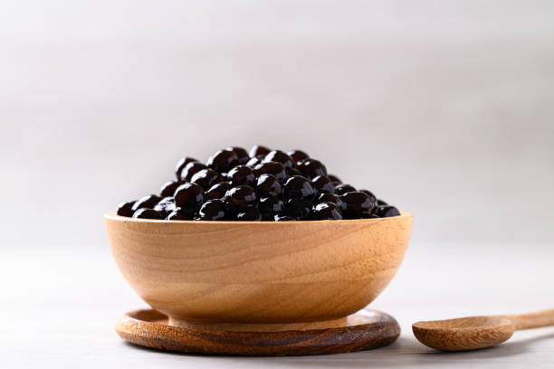 istock Black tapioca pearls or boba in wooden bowl, Ingredient in bubble tea 2156291139