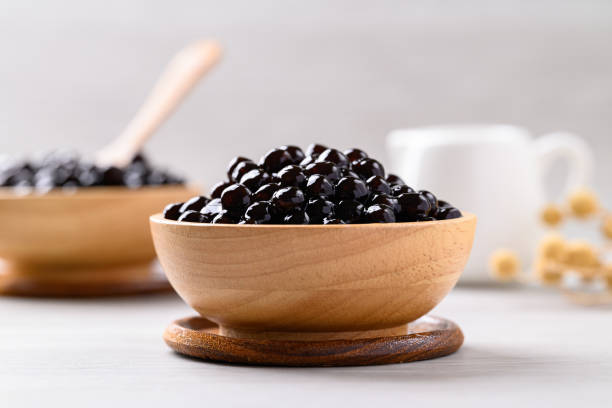 Black tapioca pearls or boba in wooden bowl, Ingredient in bubble tea