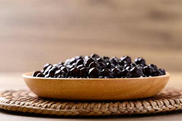 istock Black tapioca pearls or boba in wooden bowl, Ingredient in bubble tea 2156291210