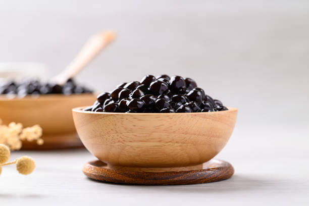 istock Black tapioca pearls or boba in wooden bowl, Ingredient in bubble tea 2156291214