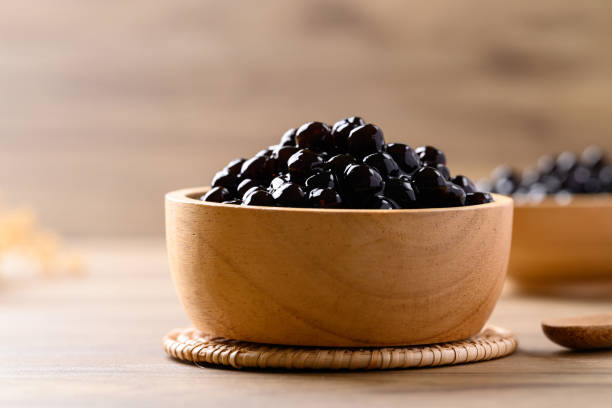 istock Black tapioca pearls or boba in wooden bowl, Ingredient in bubble tea 2156291228