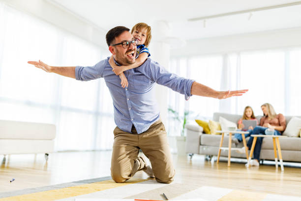 istock Playful father and son having fun on carpet at home. 2156293893