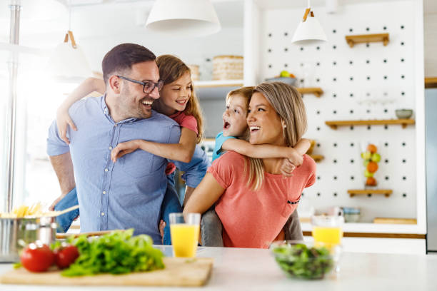 istock Young happy family piggybacking in the kitchen. 2156294034