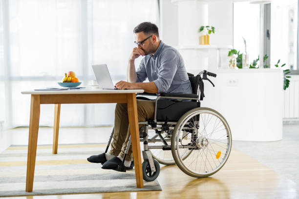 istock Disabled businessman working on laptop at home. 2156294059