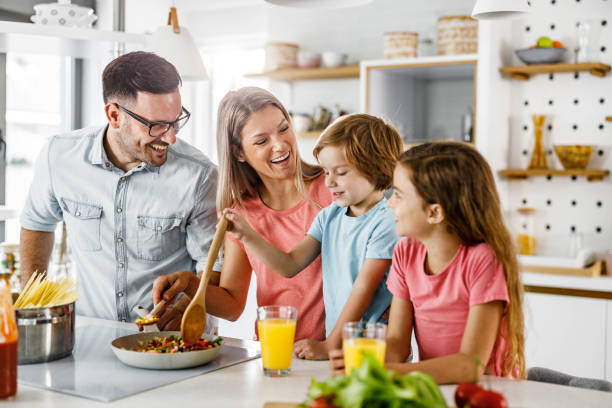 istock Happy family preparing a meal in the kitchen. 2156294115