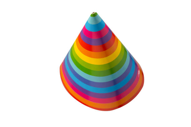 Multicolored striped party hats, balloons and decorations for party on pink background. Close-up.