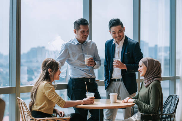 istock Coffee break Asian white collar colleague discussion with window background 2156295600