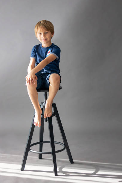 istock Cute school child, posing in studio on seamless gray background, isolated image 2156295988