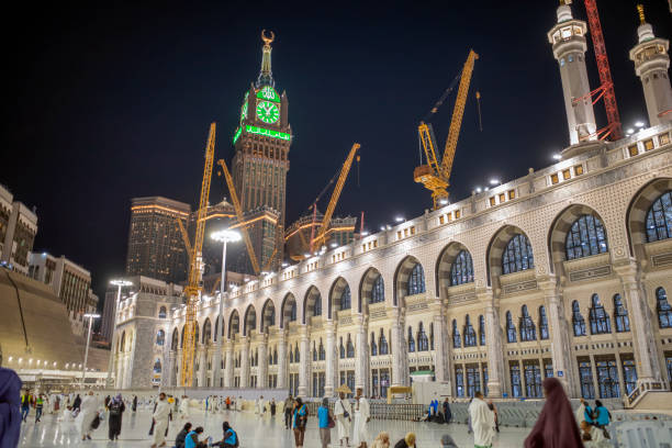 View of the Mecca Clock Tower at night during the Hajj season Mecca, Saudi Arabia - May 27, 2024: View of the Mecca Clock Tower at night during the Hajj season. makkah royal clock tower stock pictures, royalty-free photos & images