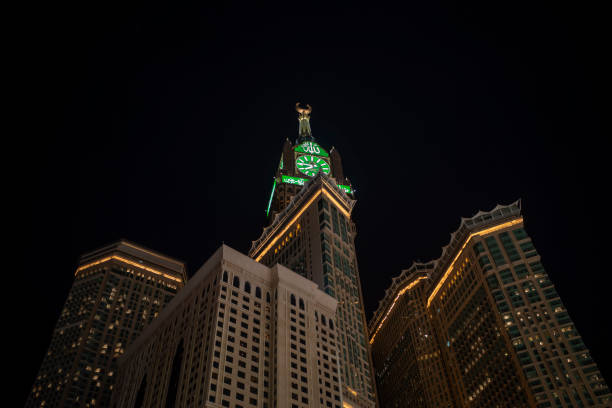 View of the Mecca Clock Tower at night during the Hajj season View of the Mecca Clock Tower at night during the Hajj season. makkah royal clock tower stock pictures, royalty-free photos & images
