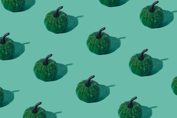 istock Trendy autumn or fall pattern made with green pumpkins on green background. Minimal autumn composition. Nature flat lay. Season concept. Pumpkin aesthetic. 2156298986