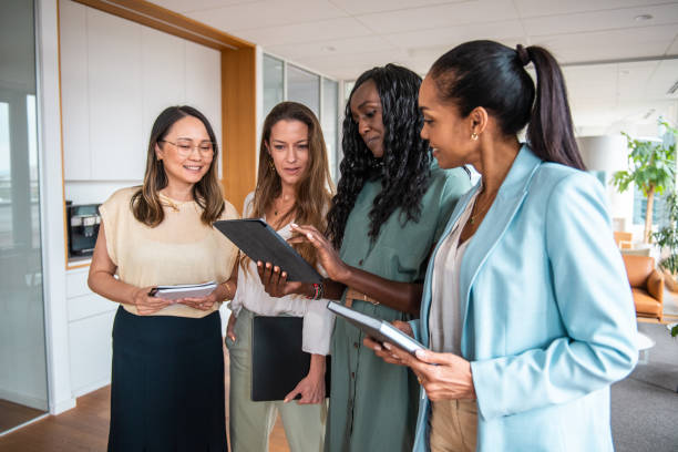 istock Diverse Businesswomen Using Digital Tablet in Office Corridor 2156299235