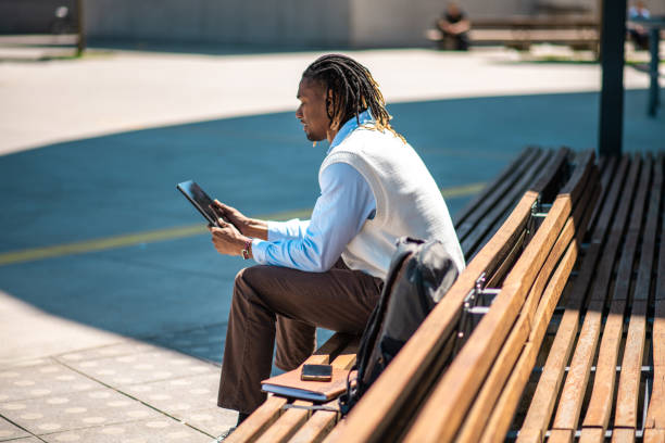 istock Focused African American Student Studying Outdoors with Tablet 2156299281