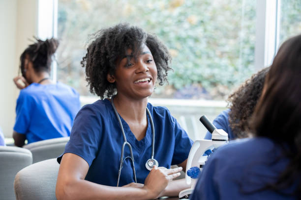 istock Donning scrub attire, a diligent medical or nursing student joins in a group discussion with classmates, their enthusiasm for the topic evident as they share insights and ask questions. 2156299817