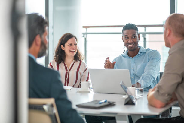 istock Smiling Business Team Engaged in Discussion 2156302514