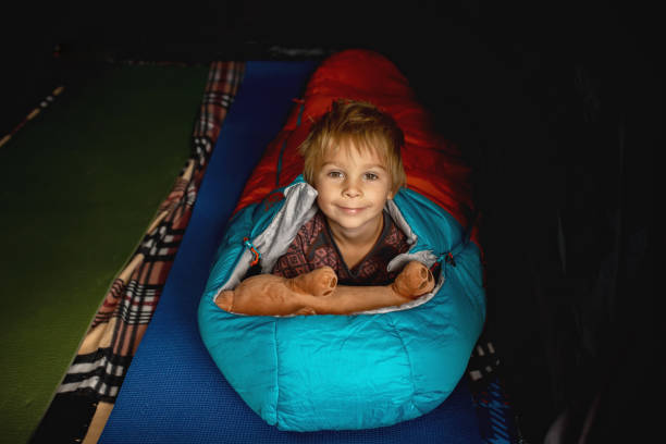 istock Children, siblings, sleeping in sleeping bags in a tent in Norway 2156302546